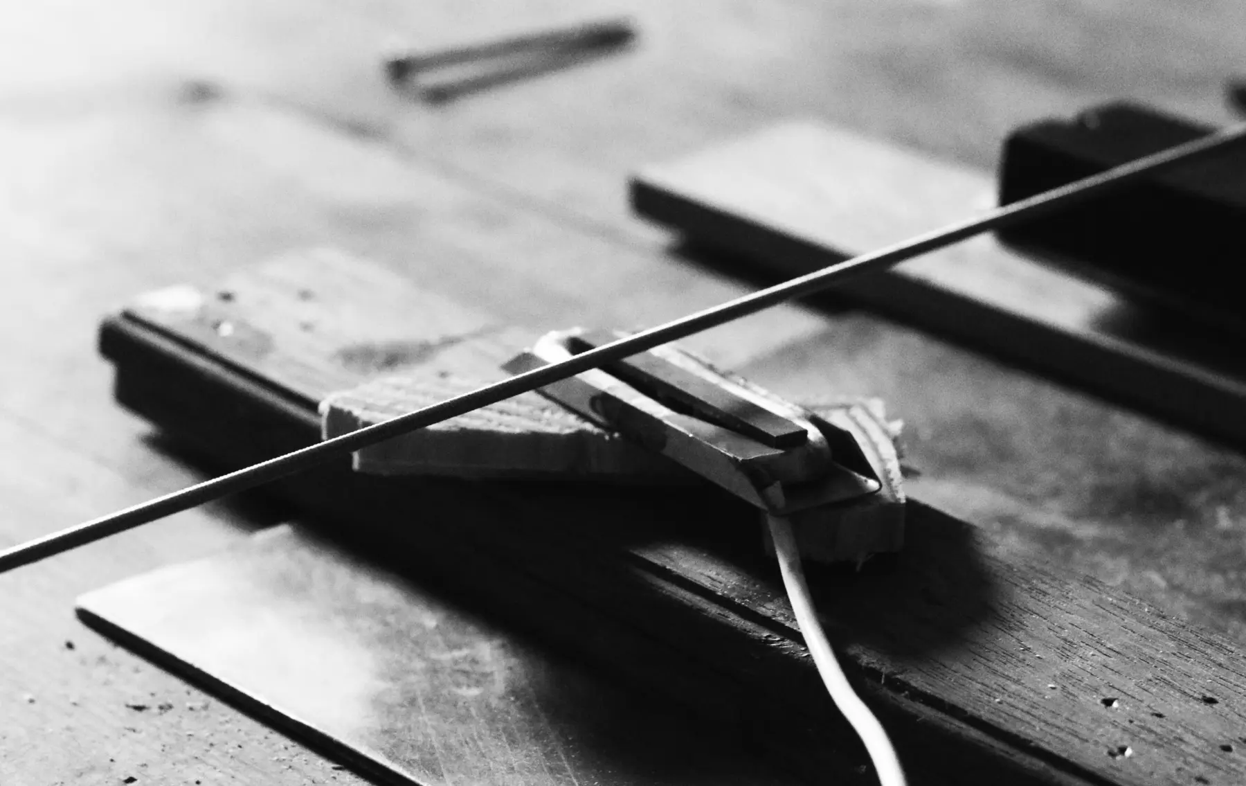Experimental long bass string fixed to a wooden floor in 2018
